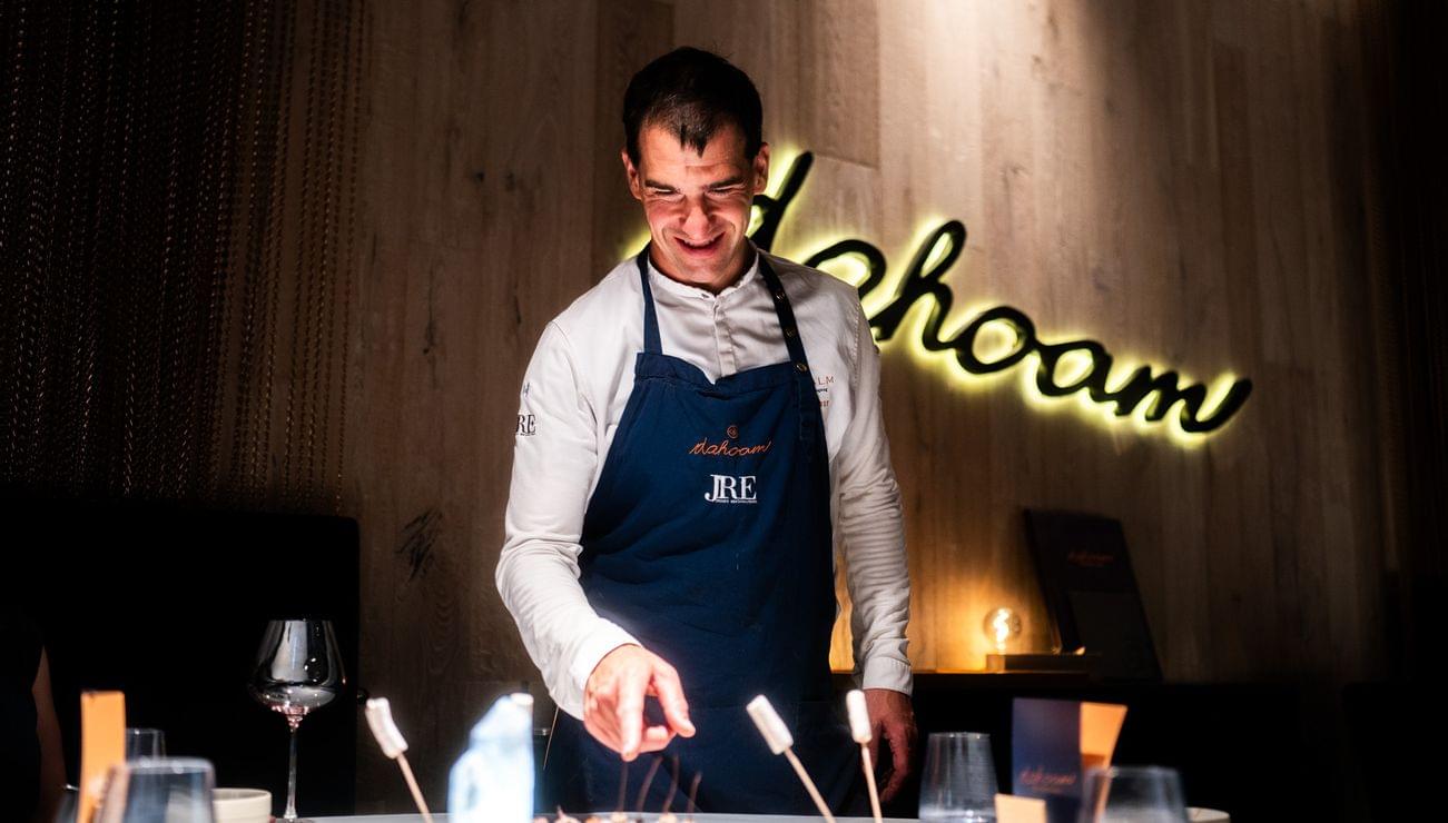 Koch im Restaurant richtet Gourmet-Vorspeisen unter warmem Licht an
